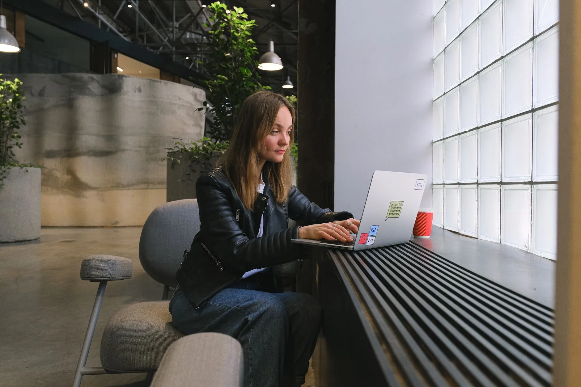 A person working on web design in a modern office workspace