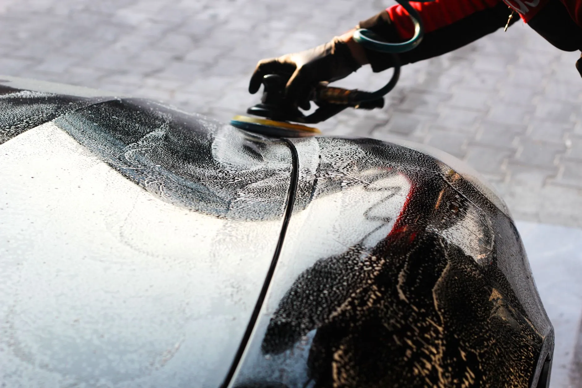 Close-up of a car being hand-polished during a detailing job