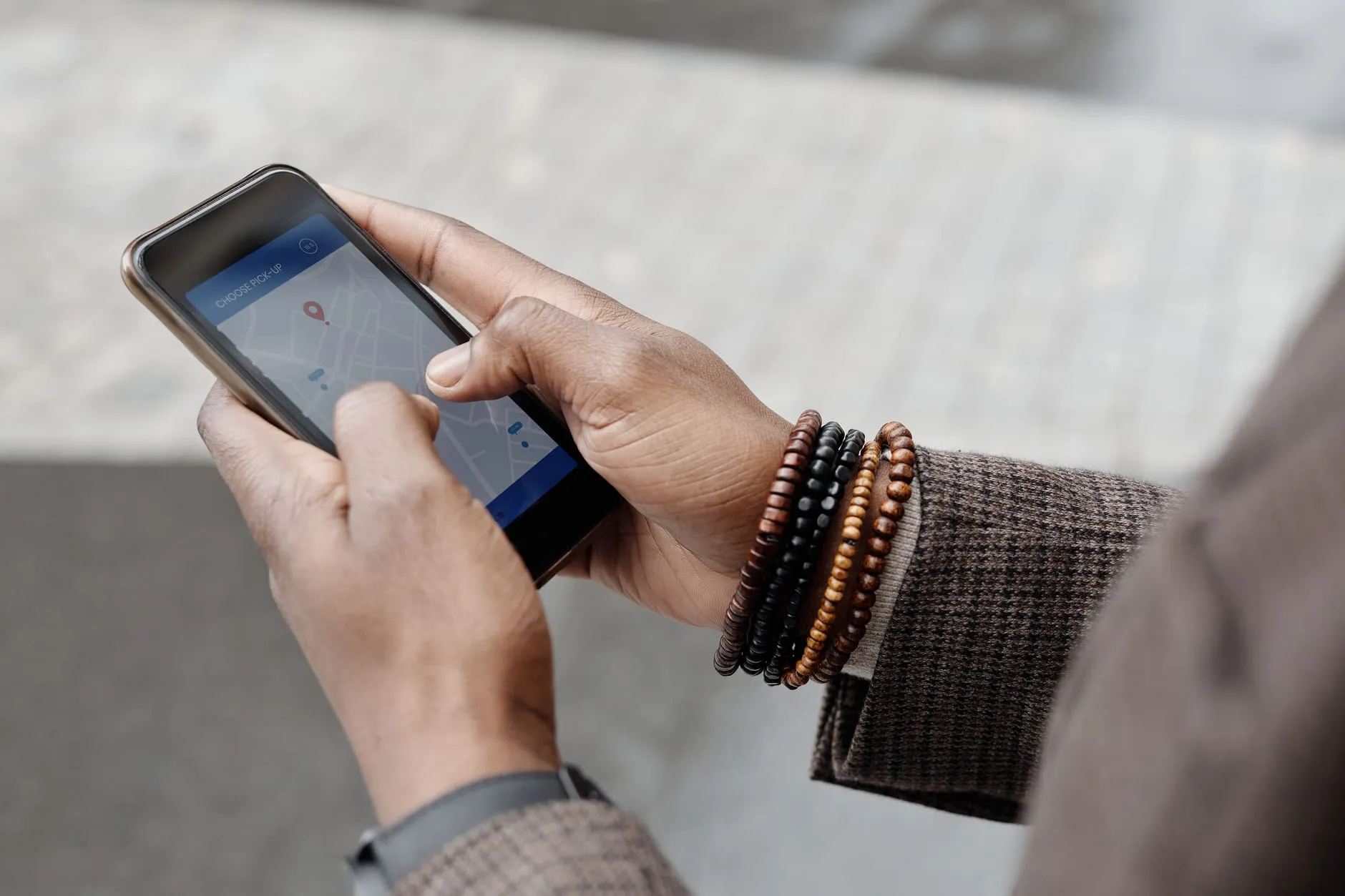 Hands holding a smartphone showing a map app