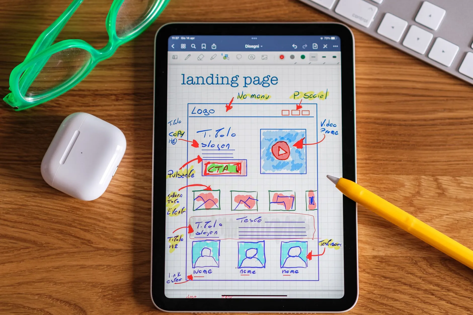 A tablet showing a hand-drawn wireframe of a landing page, an early step in building a website from scratch