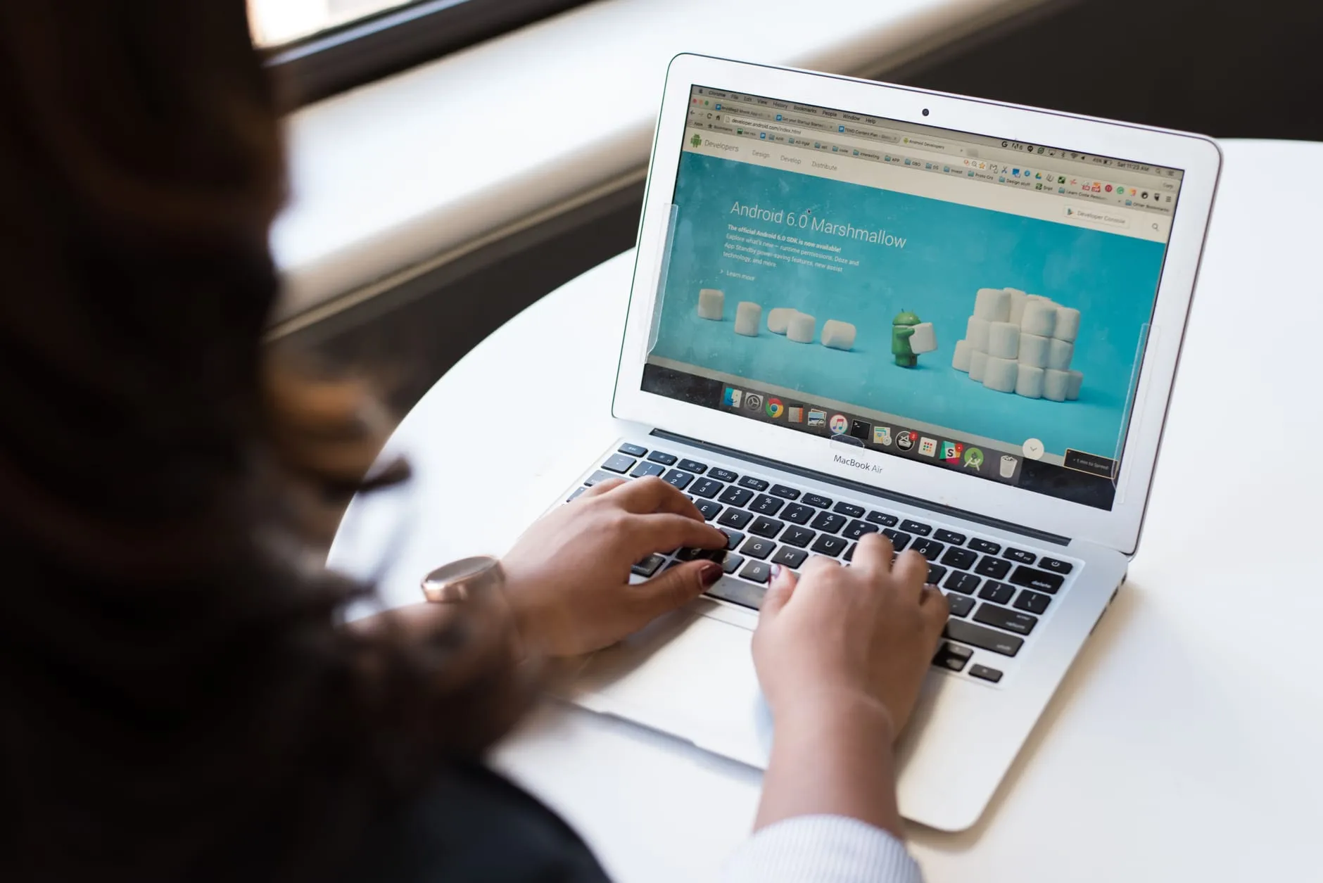 A person browsing a website on a laptop, representing common small business website mistakes
